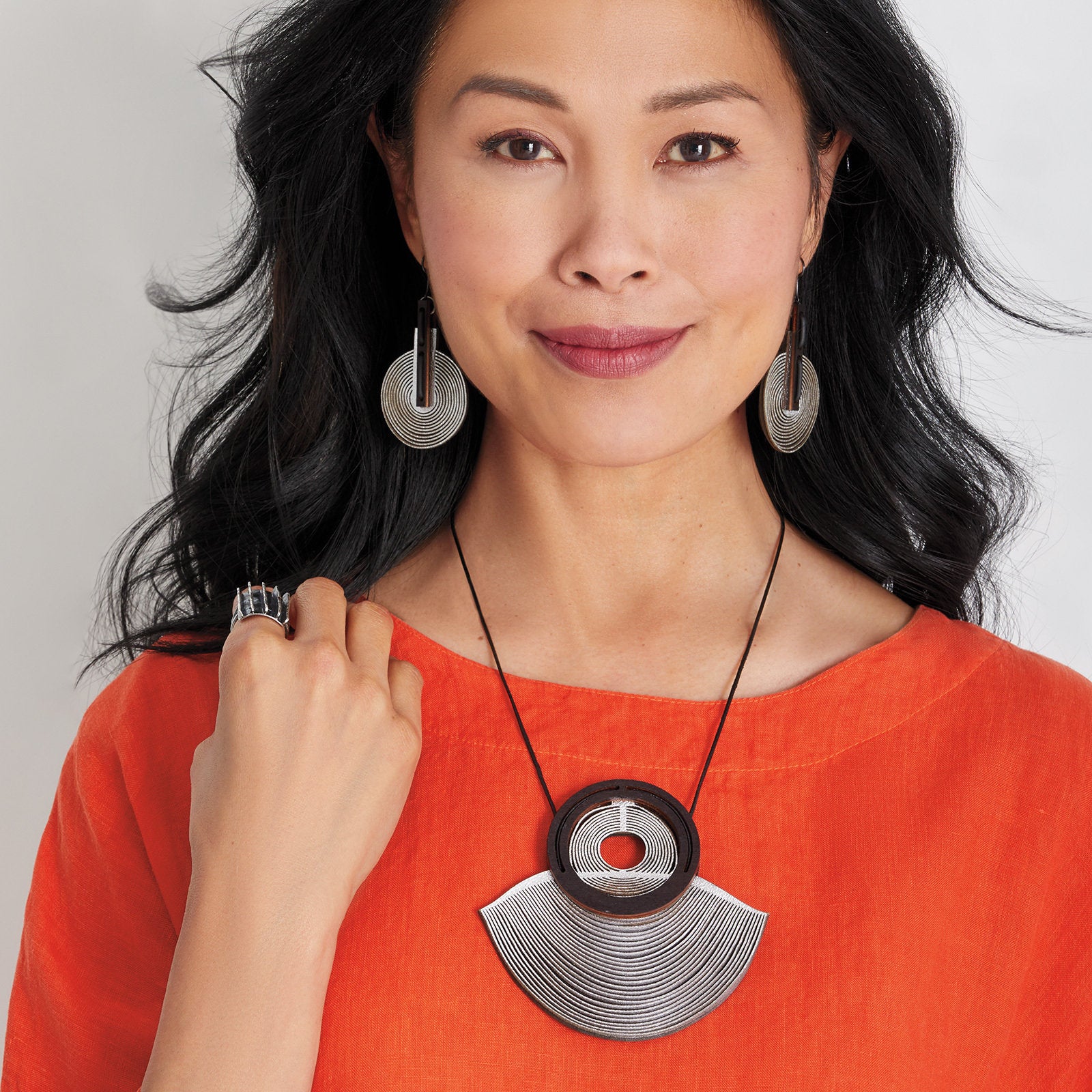 Silver Metallic Leather, shown with the artist's area 51 earrings