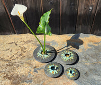 The four smallest sizes of Lens vases in tricolor patina, with lily.