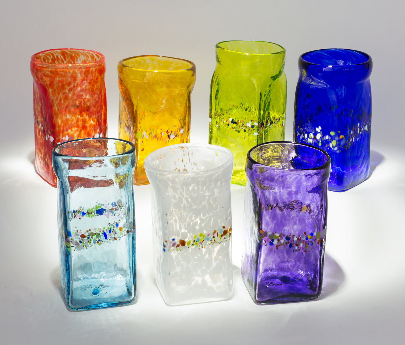 back to front, left to right: red, gold, lime, cobalt, aqua, white, purple