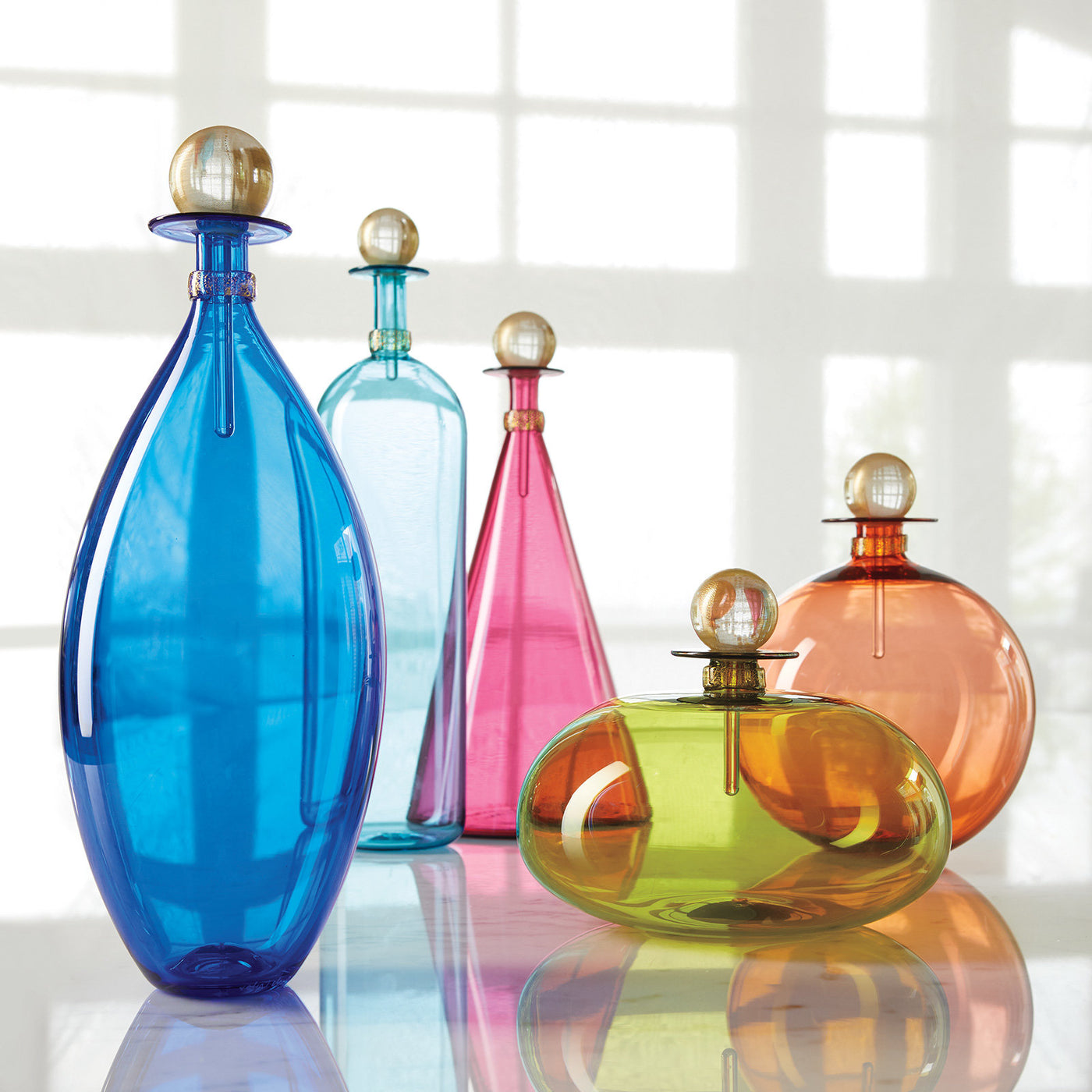 left to right: Cerulean Ellipse, tall copper blue bottle, medium ruby cone, olive squat orb, apricot sphere