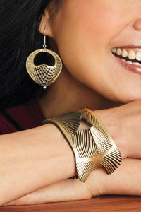 Gold Metallic Leather, shown with the artist's Seed-Pod Earrings