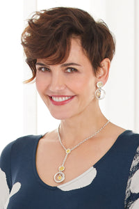 shown with the artist's Solar Earrings