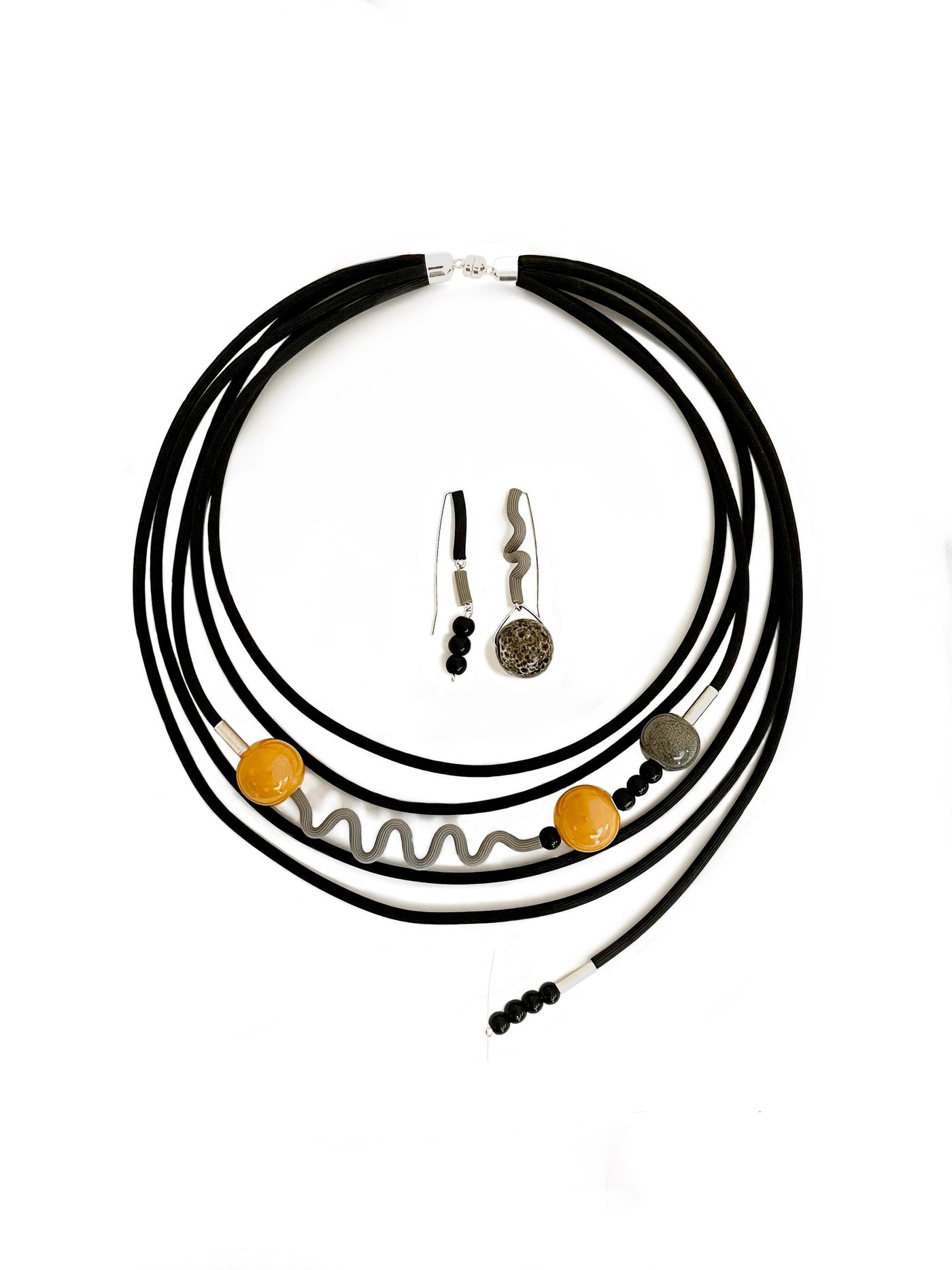 shown with the artist's coordinating ray of sunshine necklace