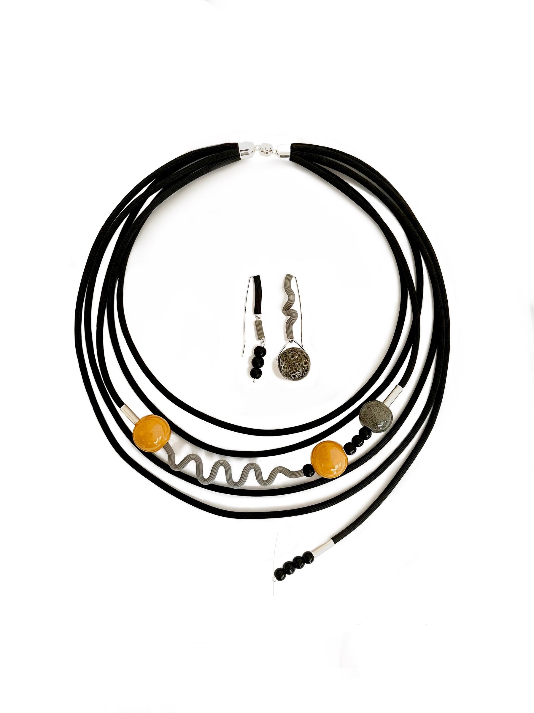 shown with the artist's coordinating ray of sunshine necklace