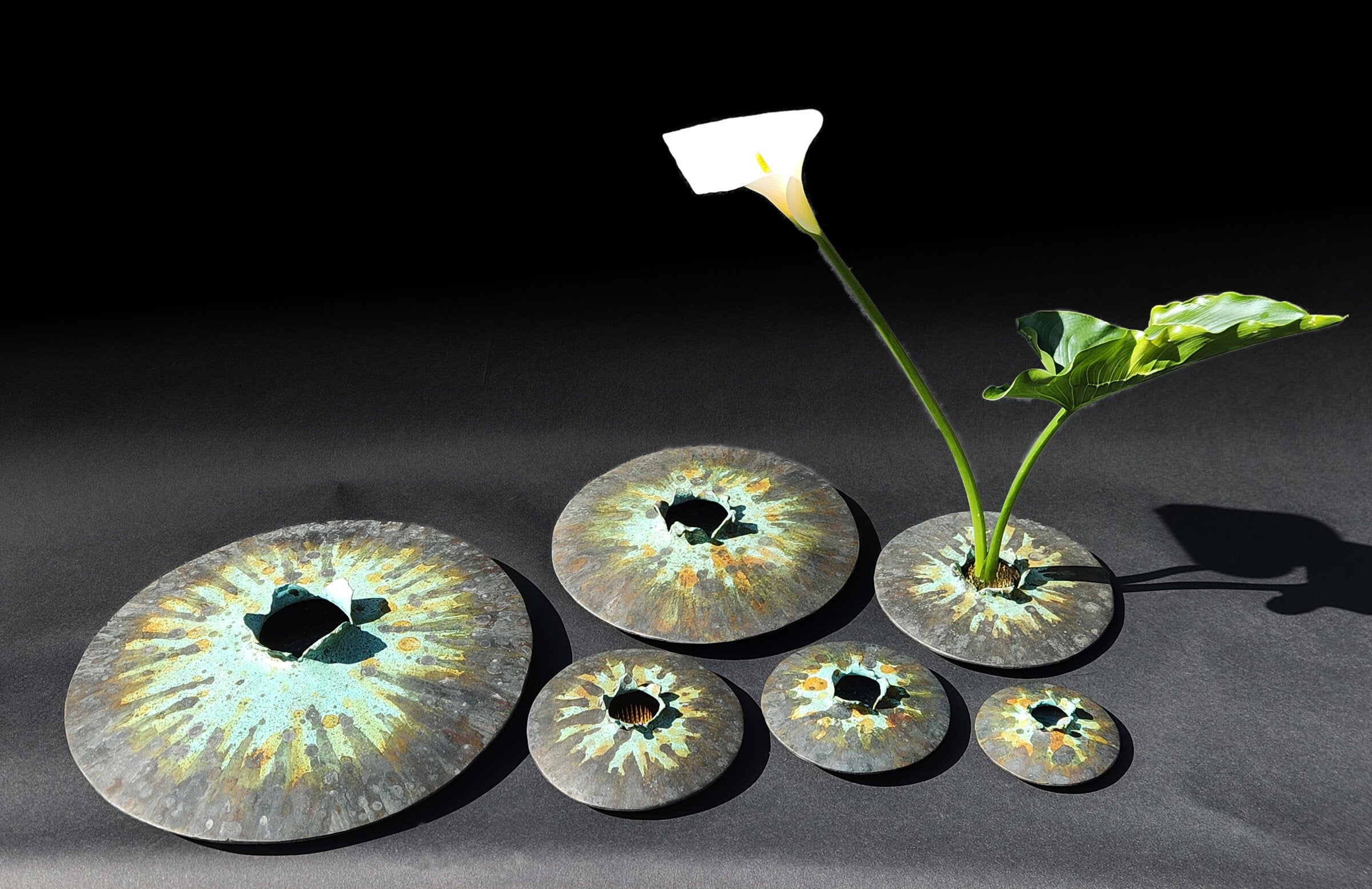 All six sizes of Lens vase in tricolor patina.