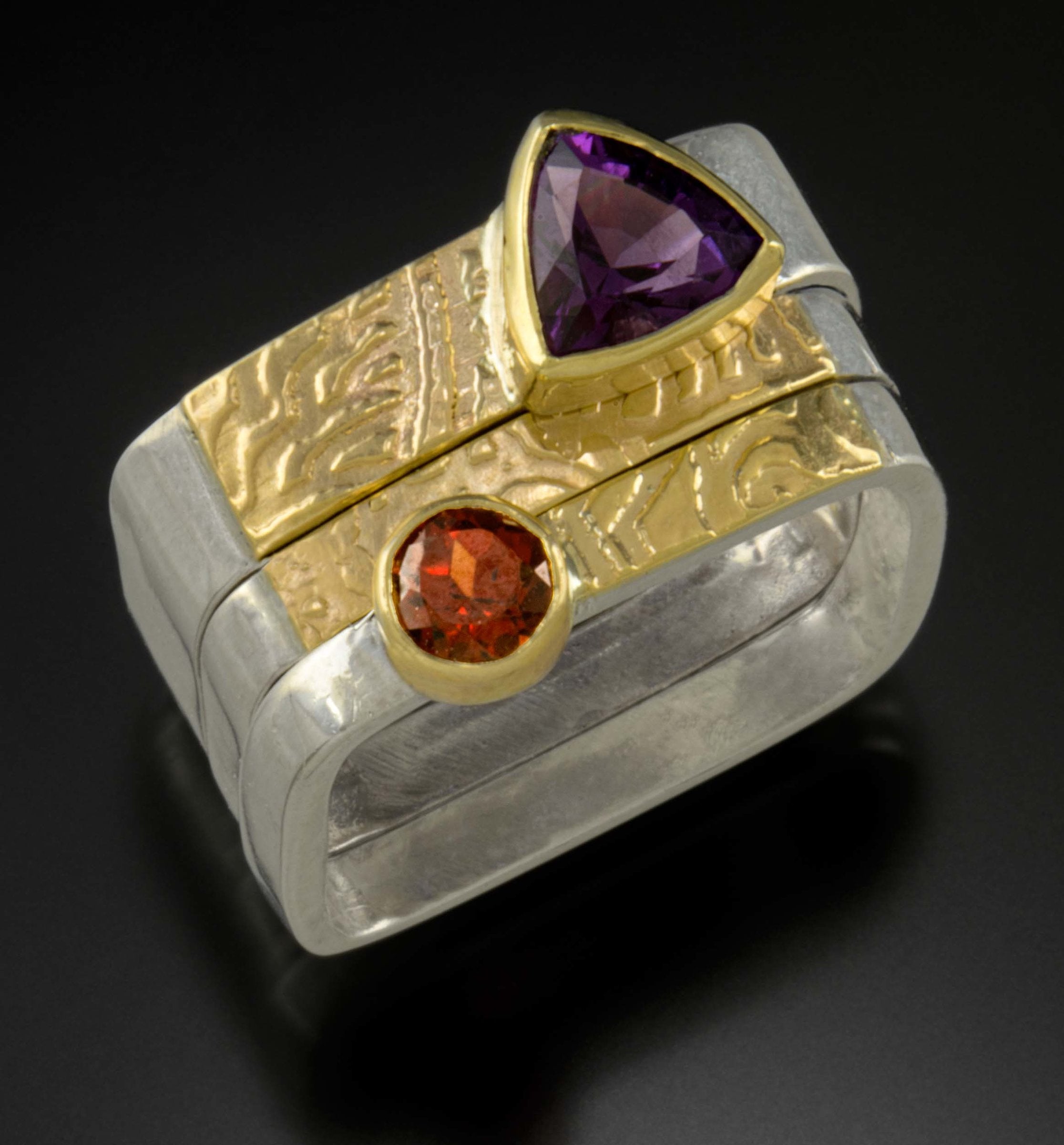 top to bottom: Amethyst Trillion Ring, gold and silver band, Rhodolite Garnet ring