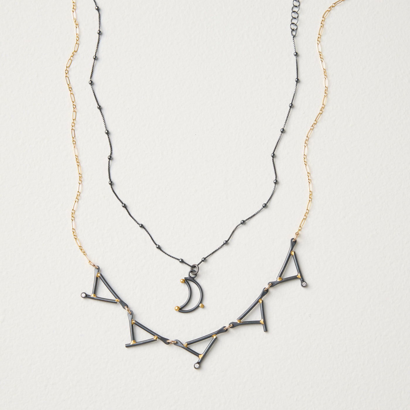 shown with the artist's Small Moon Pendant