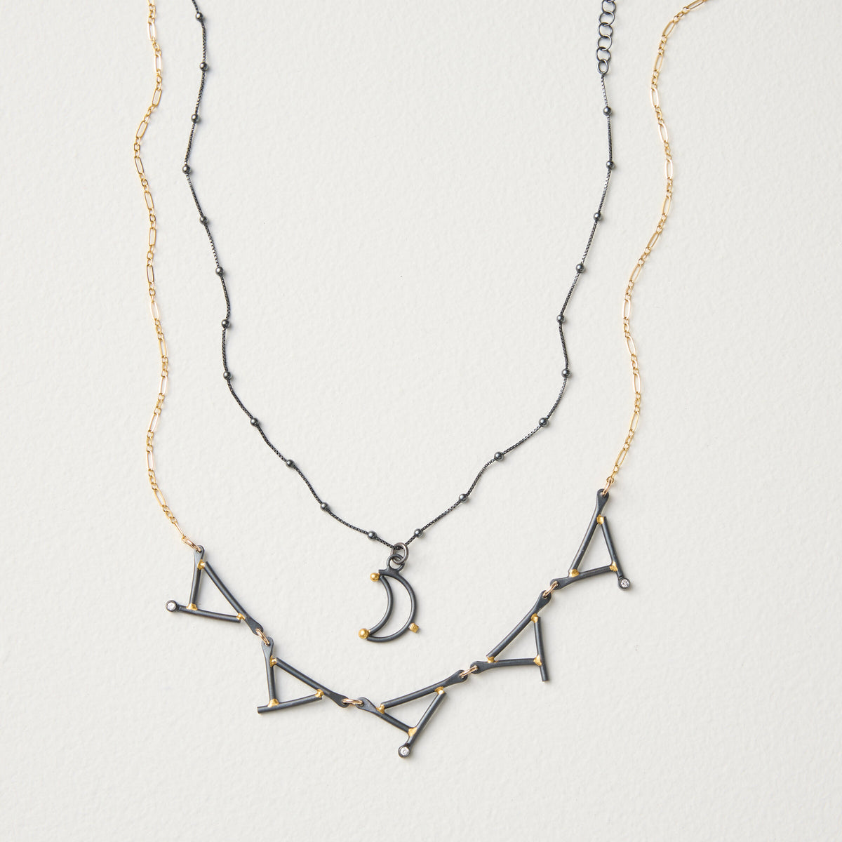 shown with the artist's Small Moon Pendant