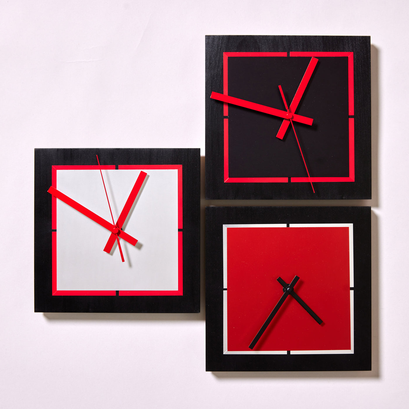 clockwise from left:  silver with red border and hands, onyx with red border and hands, red orange sapphire with silver border and black hands | Photo by Steve Smith Photography