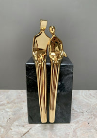 gold with black marble base