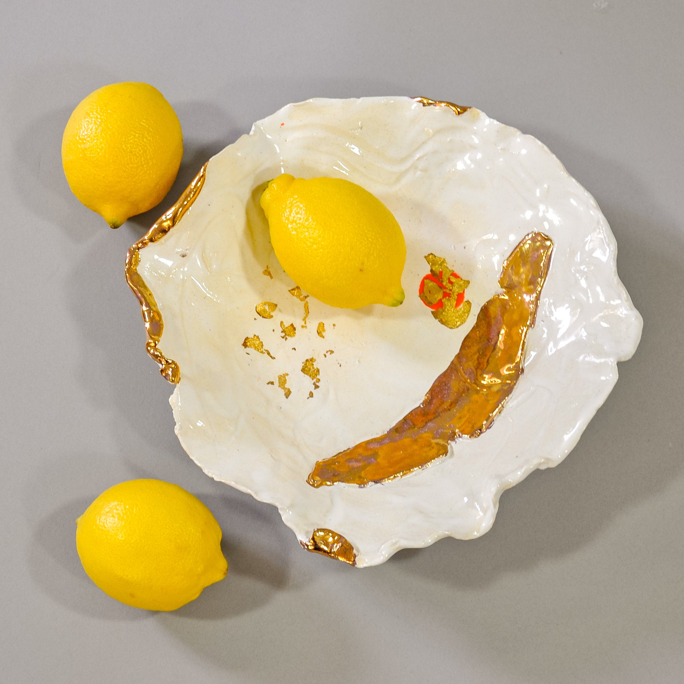 White Bowl with Gold Accents and a Touch of Orange