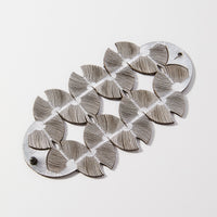 Hand forged anticlastic sterling silver is shaped into a gentle, graceful form. The backs slip into a hollow form to create a sleek, continuous look.  Sterling silver ear wires.