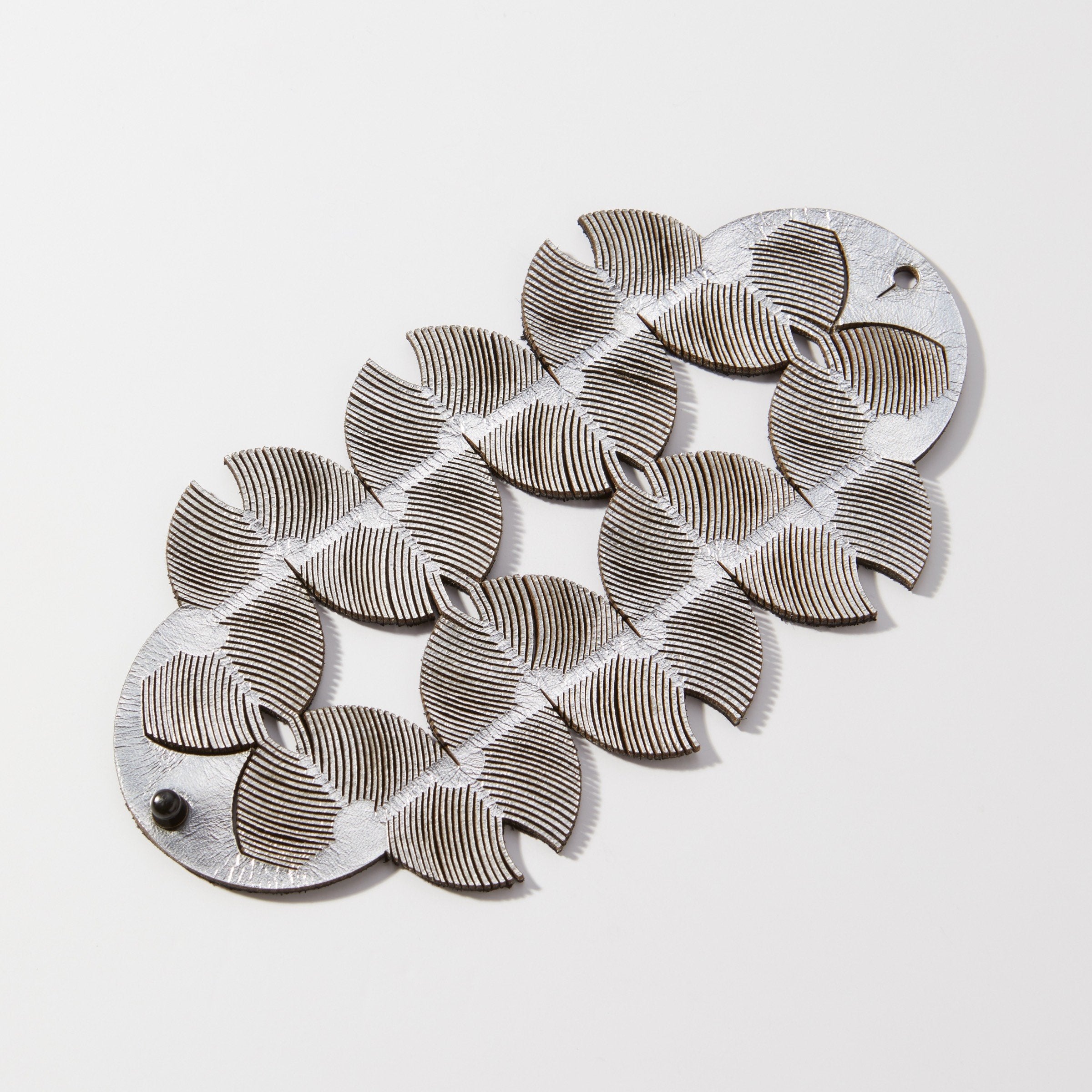 Hand forged anticlastic sterling silver is shaped into a gentle, graceful form. The backs slip into a hollow form to create a sleek, continuous look.  Sterling silver ear wires.