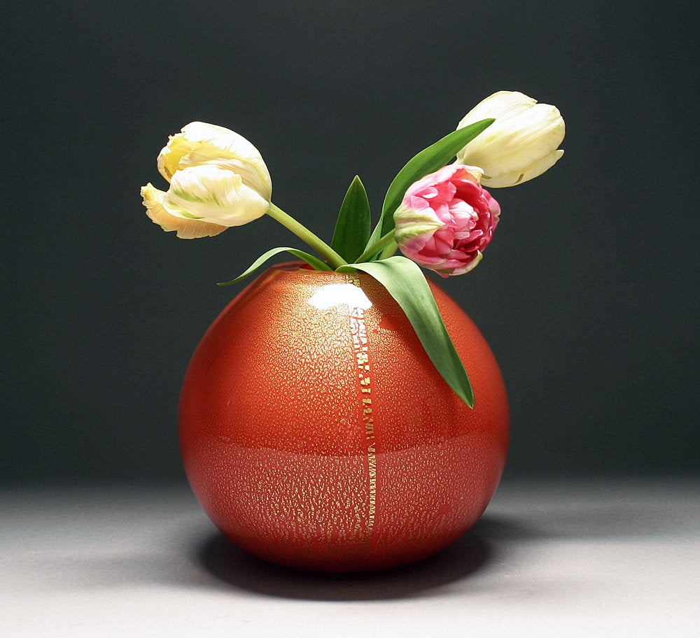 gold vase in red