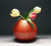 gold vase in red