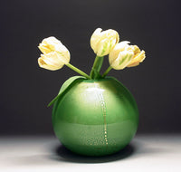 gold vase in green