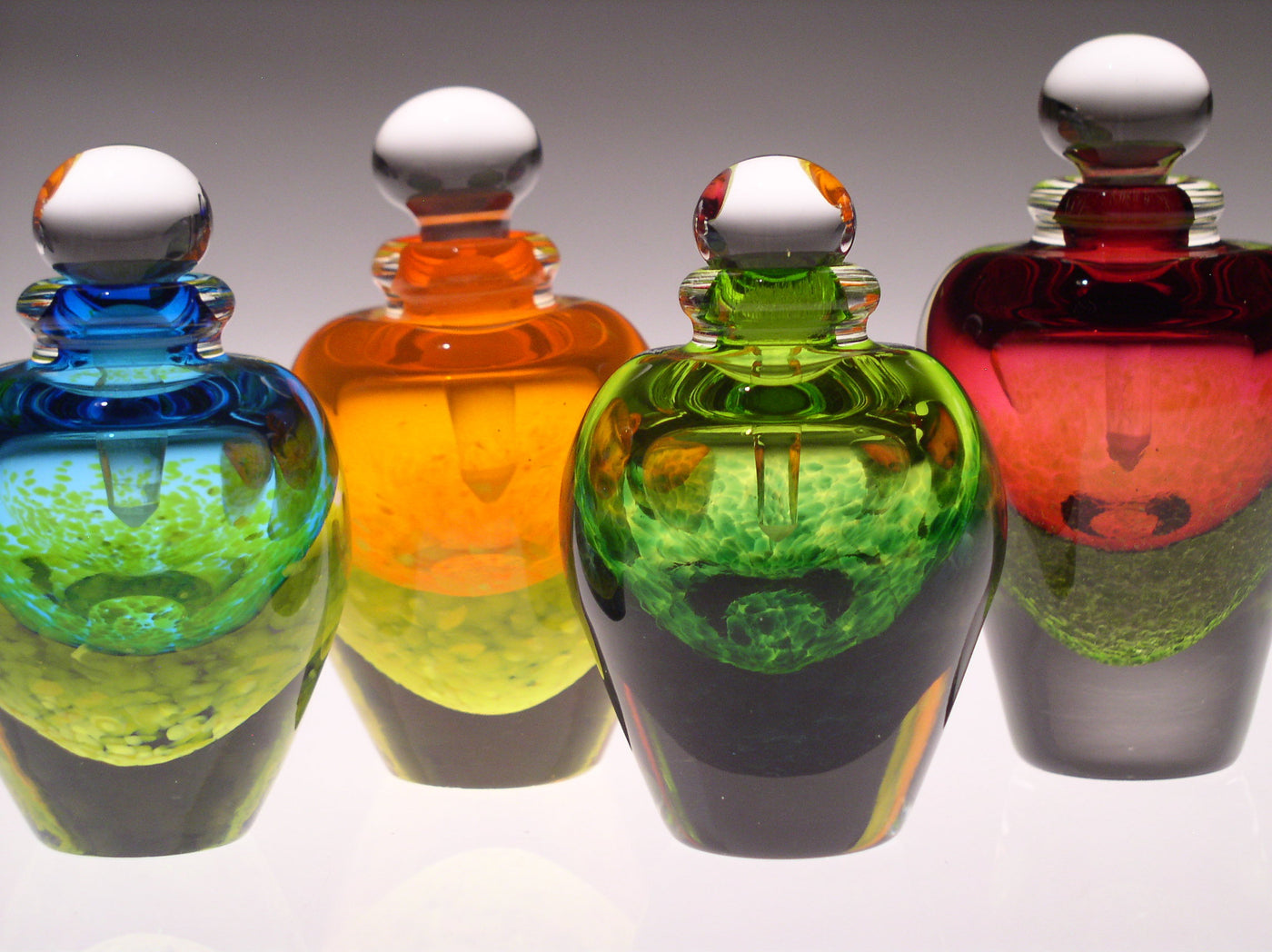 left to right: turquoise, orange, green, ruby