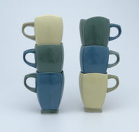 Left stack top to bottom: yellow, green, blue; right stack top to bottom: green, blue, yellow