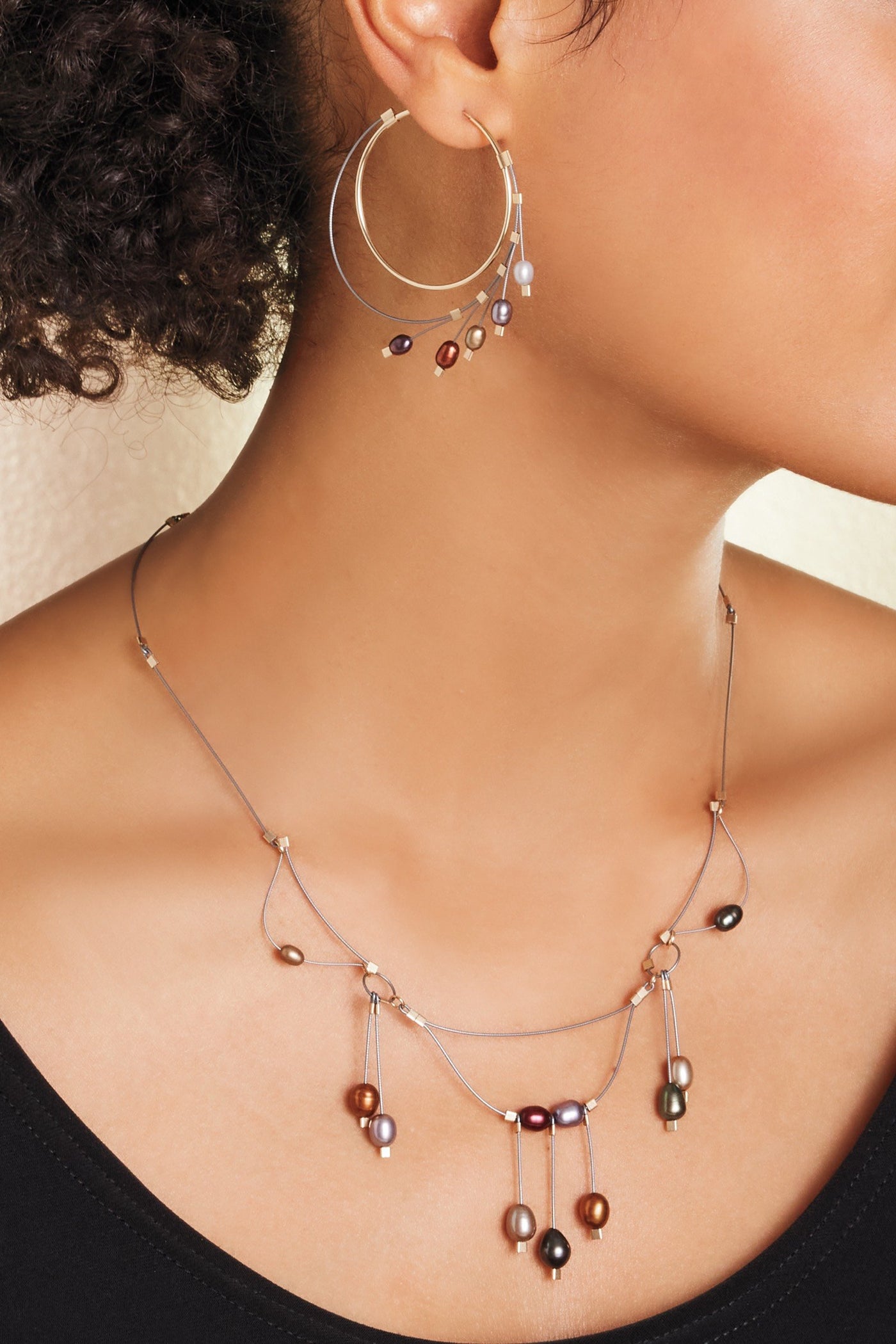 shown with the artist's large spring hoops