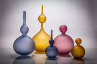 left to right: Large Midnight Perle Bottle, Amber Perle Double Bottle, Small Midnight Perle Bottle, Large Purple Perle, Small Burnt Amber Perle