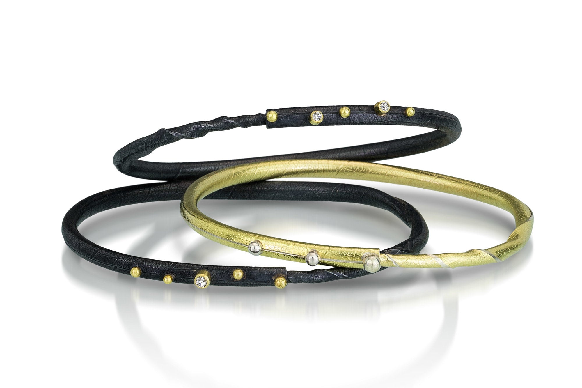 from top to bottom: oxidized with two diamonds, gold finish, oxidized with one diamond