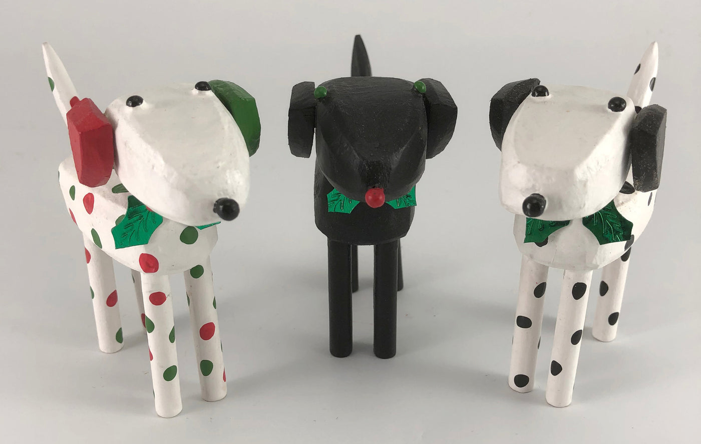 left to right: red and green dalmatian, black lab, dalmatian