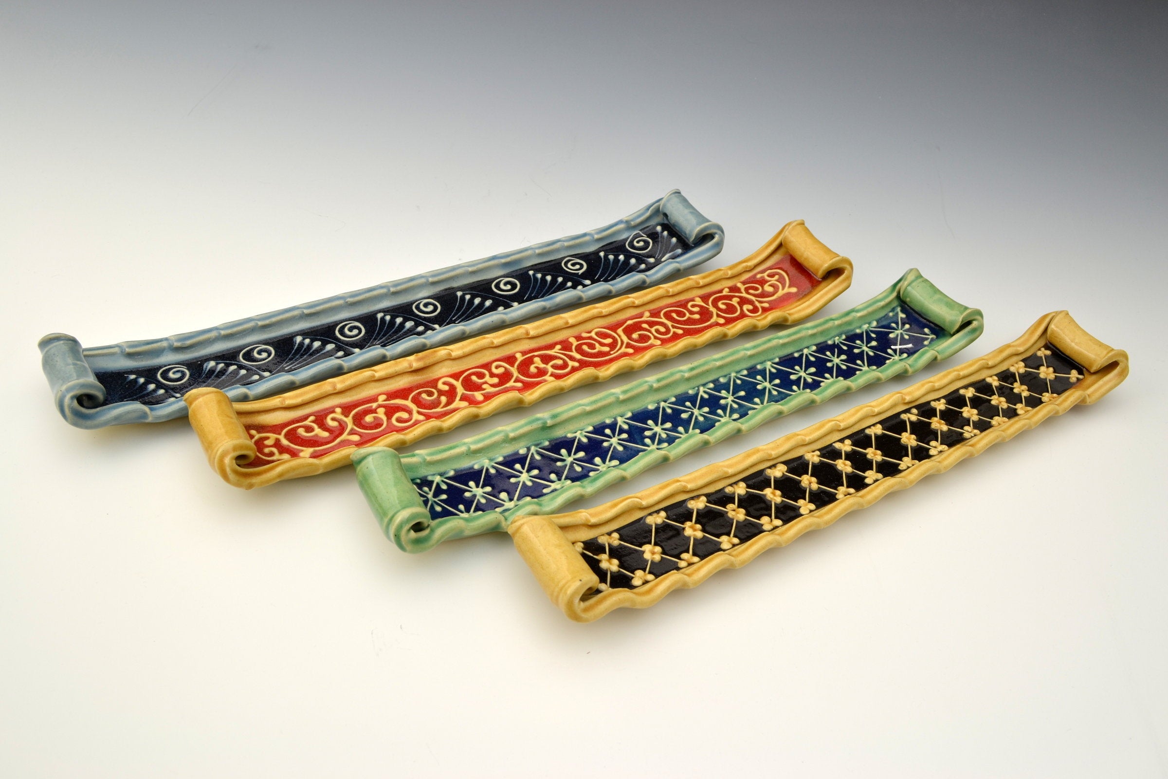 left to right: blue with black accent, honey with red accent, green with blue accent, honey with black accent
