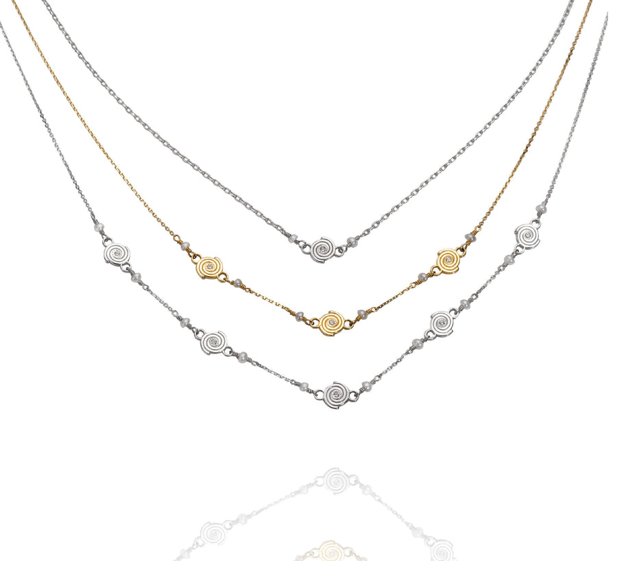 Single Spiral Necklace in Argentium Silver, Triple Spiral Necklace in 14k Yellow Gold, and Five Spiral Necklace in Argentium Silver