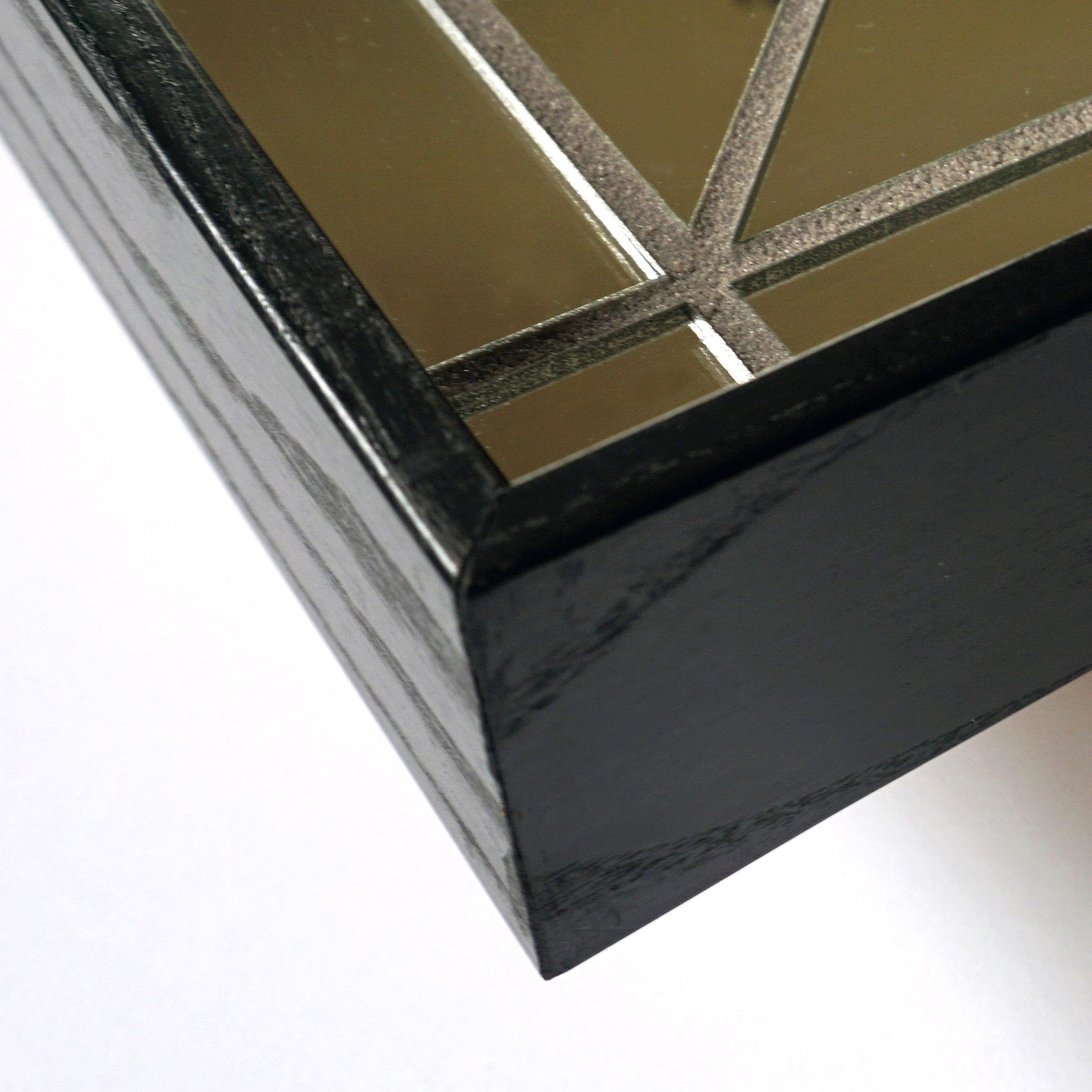 Corner detail of black framed mirror "Equis 12x24"