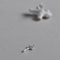 Coral Charm in Bright Silver, next to natural coral