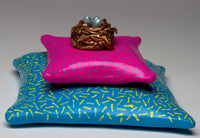 Nest on Pink Pillow