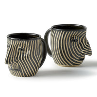 left to right: vertical lines face mug, spiral face mug