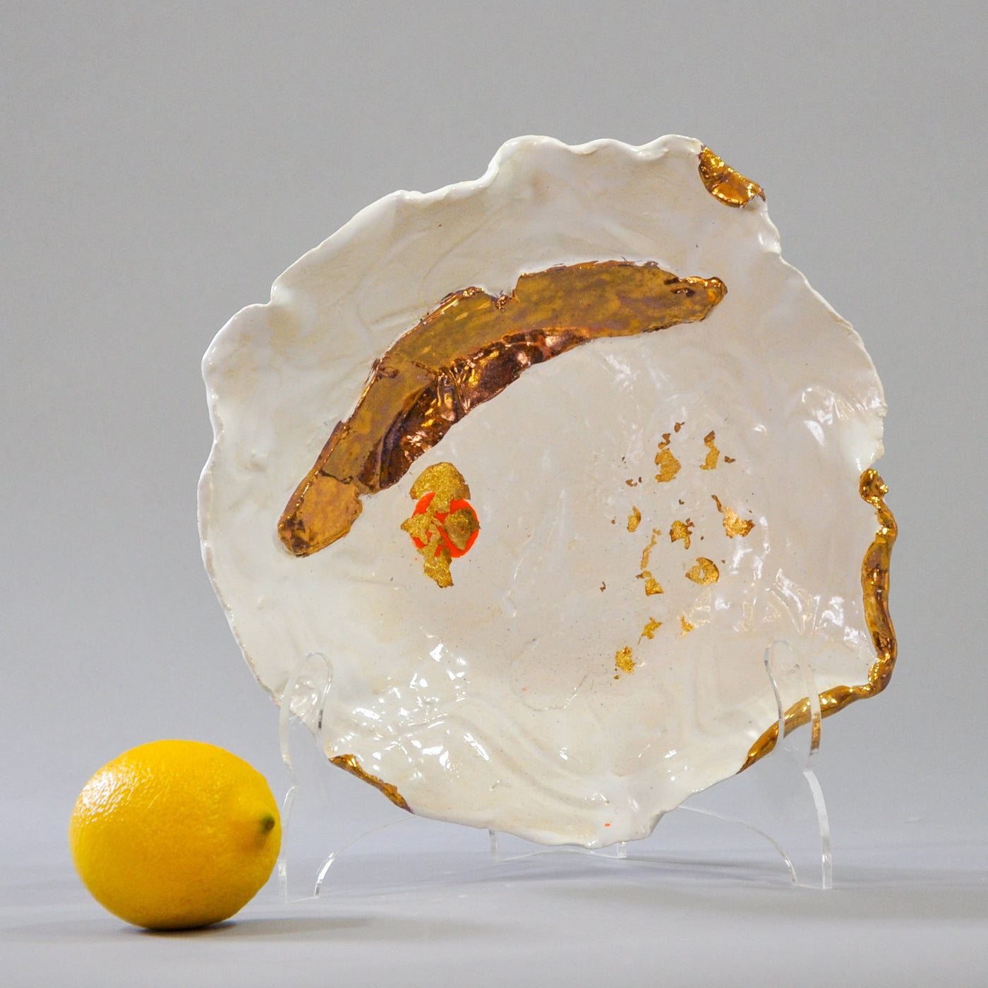 White Bowl with Gold Accents and a Touch of Orange