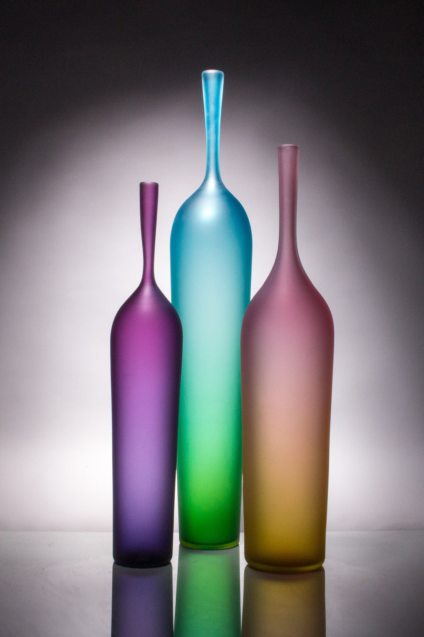 left to right: short purple/blue, tall blue/green, medium pink/gold