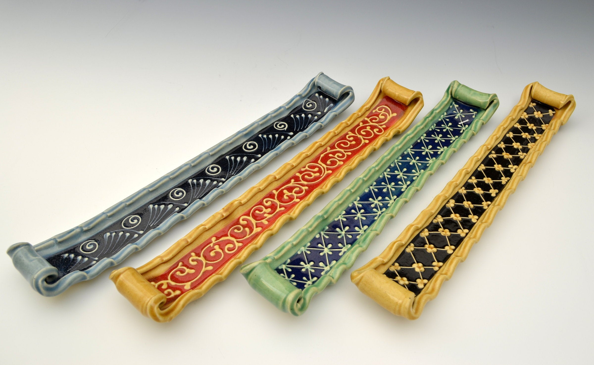 left to right: blue with black accent, honey with red accent, green with blue accent, honey with black accent