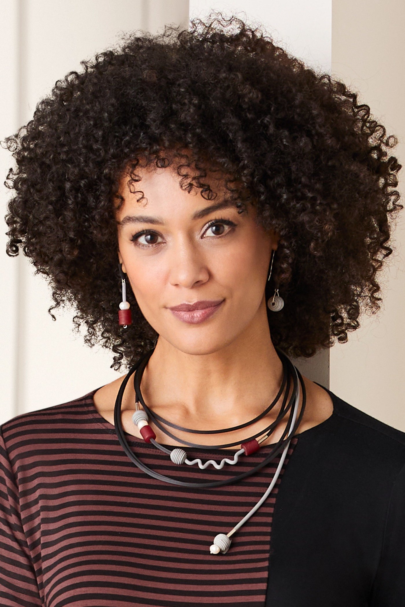 shown with the artist's spiced vine earrings