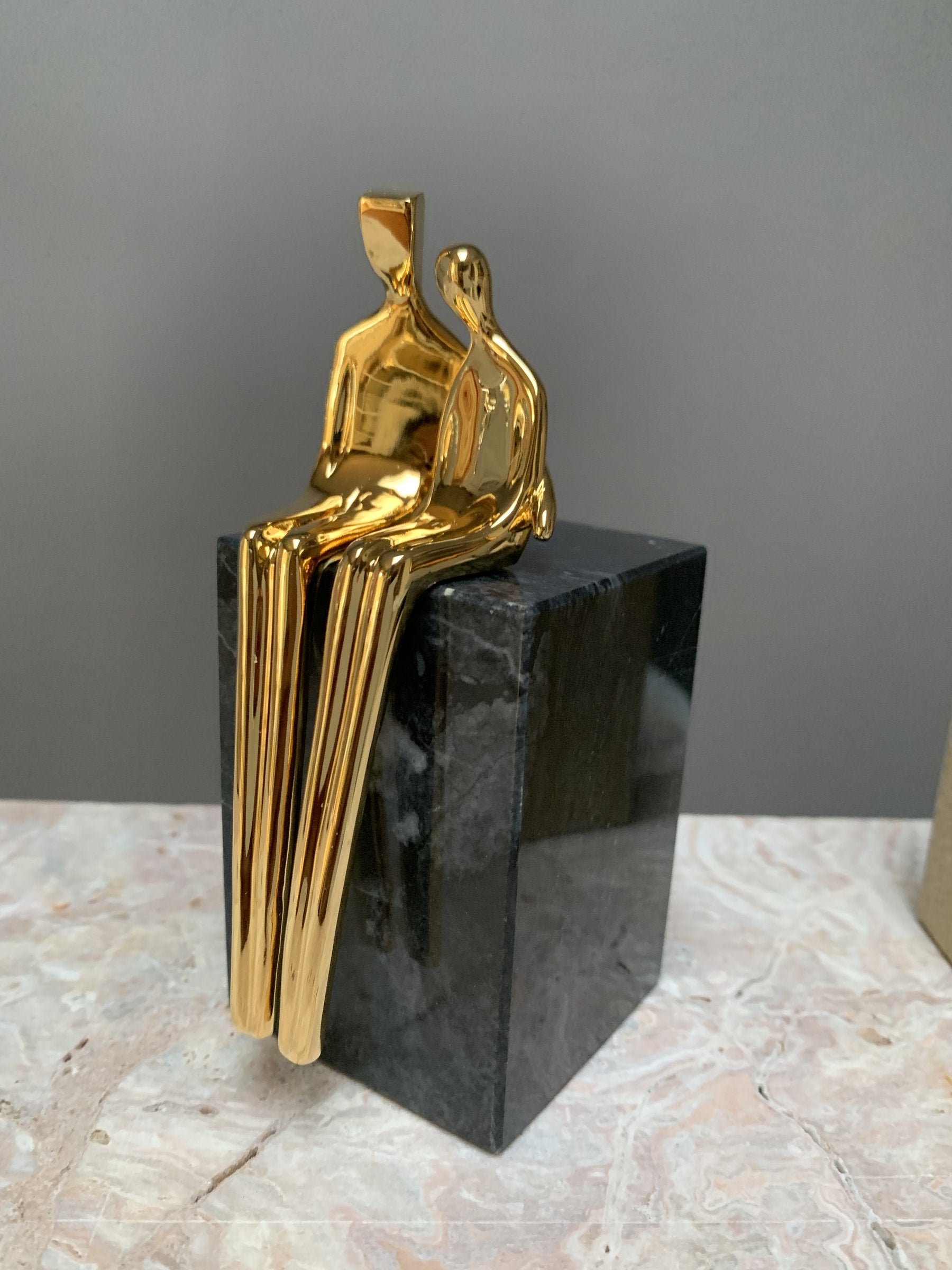 gold with black marble base