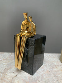 gold with black marble base