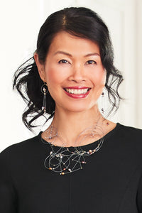 shown with the artist's trapeze necklace