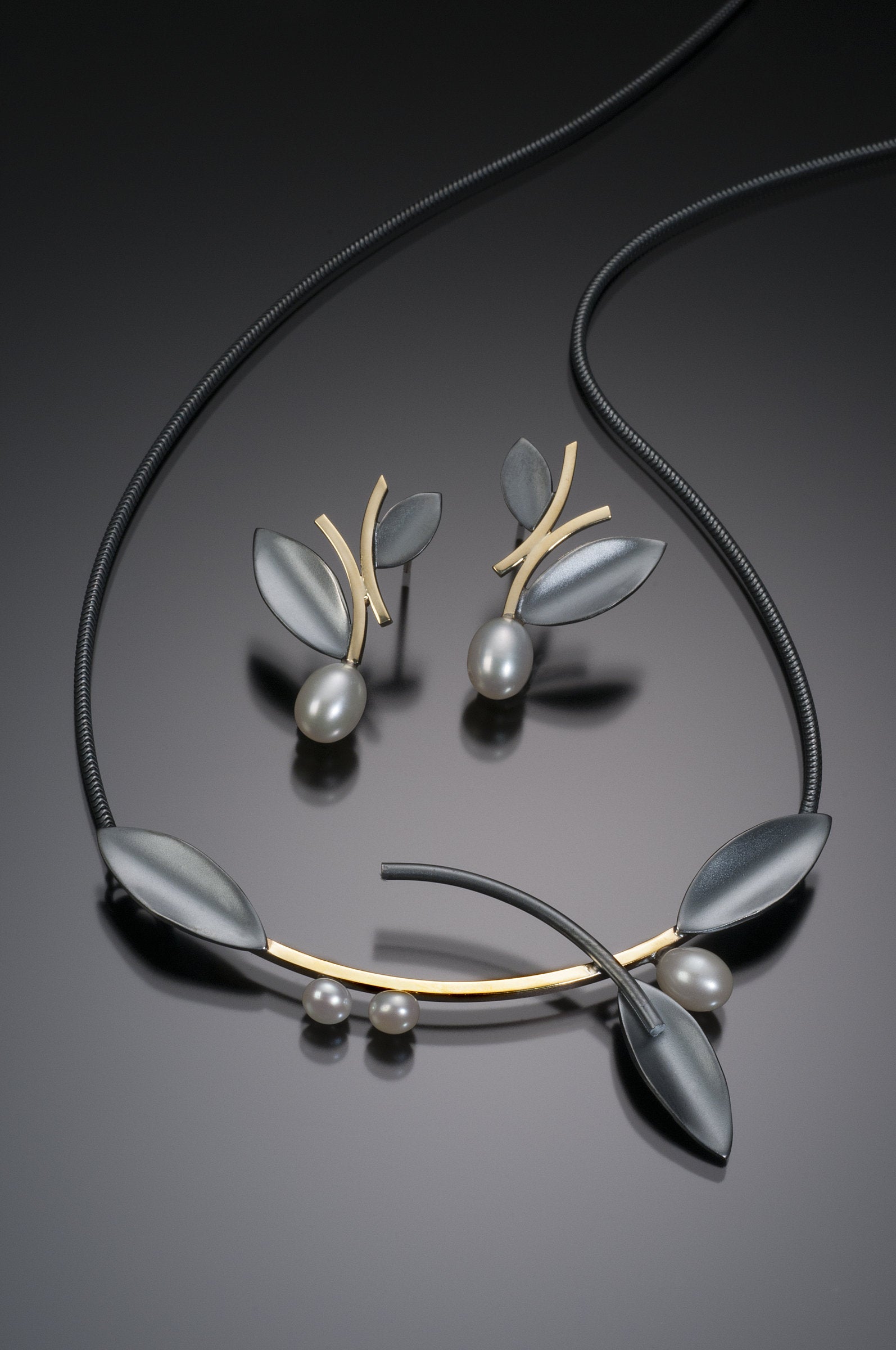 Oxidized Silver and Gold, shown with the artist's coordinating alternating leaf earring with pearl