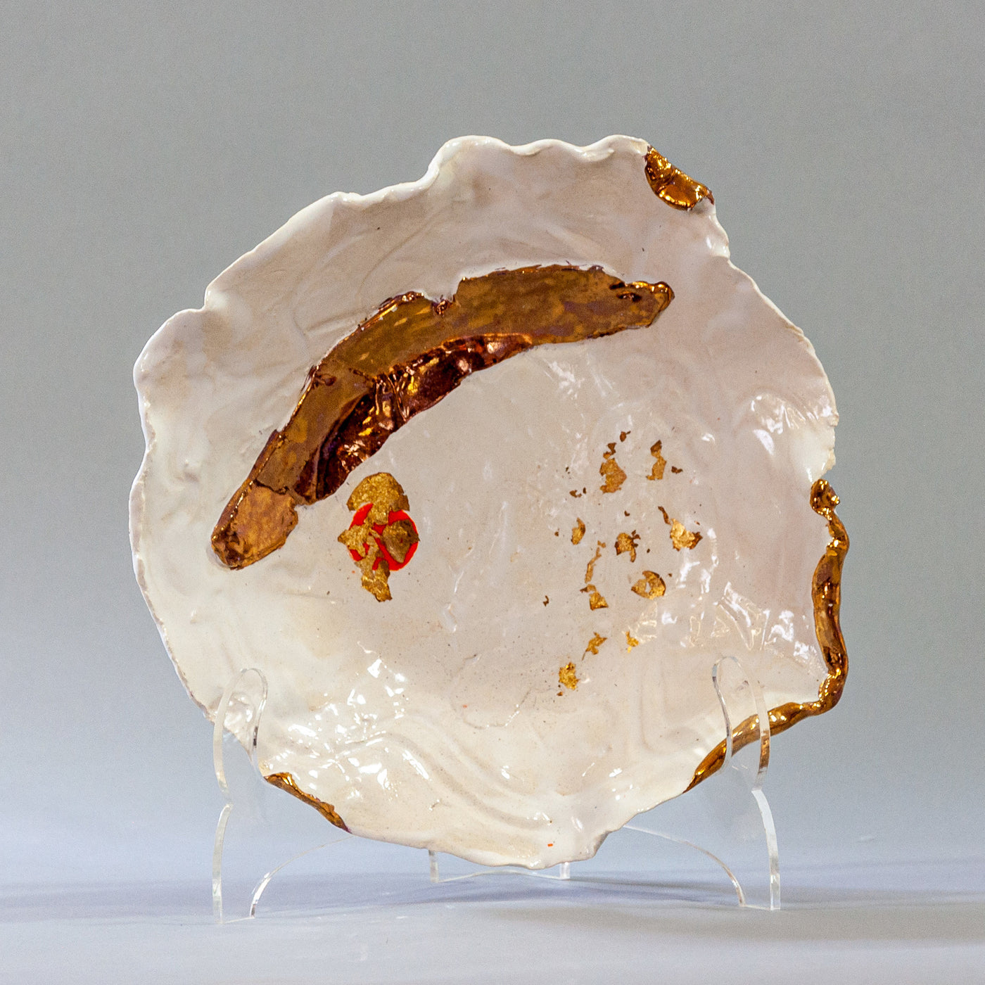 White Bowl with Gold Accents and a Touch of Orange