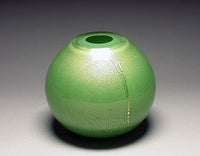 gold vase in green