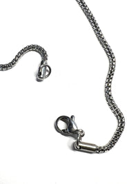 Stainless steel chain with lobster claw clasp | Photo by Artist