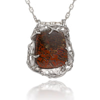 Petrified Dinosaur Bone Pendant | Photo by Berlian Arts