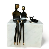 Bronze with curled up cat