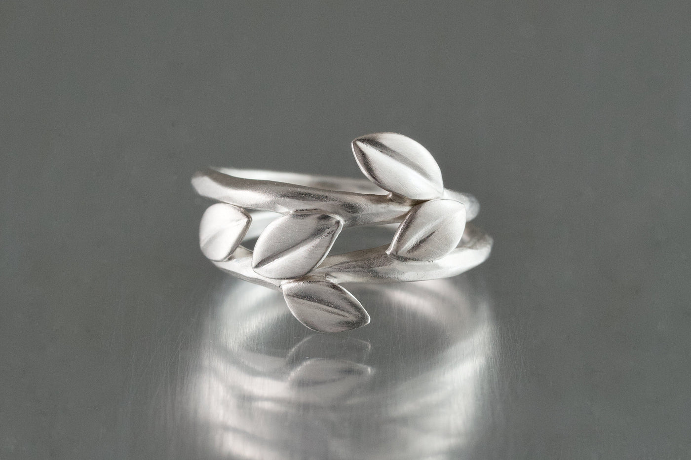 shown with the artist's triple leaf ring