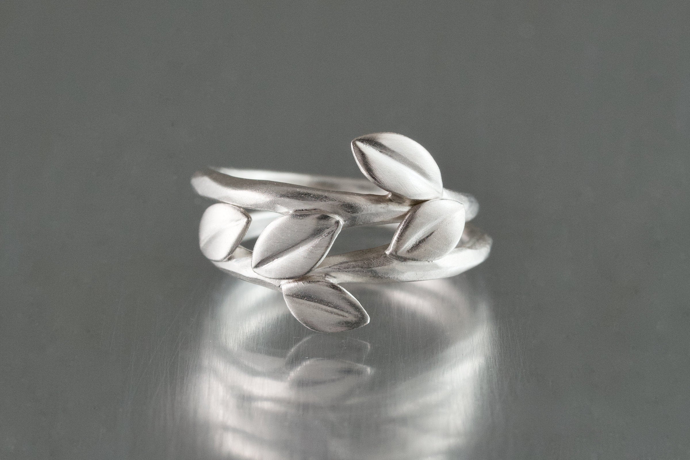 shown with the artist's triple leaf ring