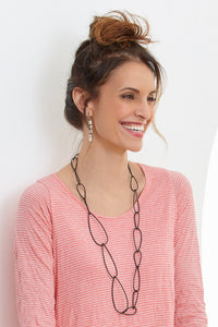 steel, shown with the linked tube earrings by laurette o'neil