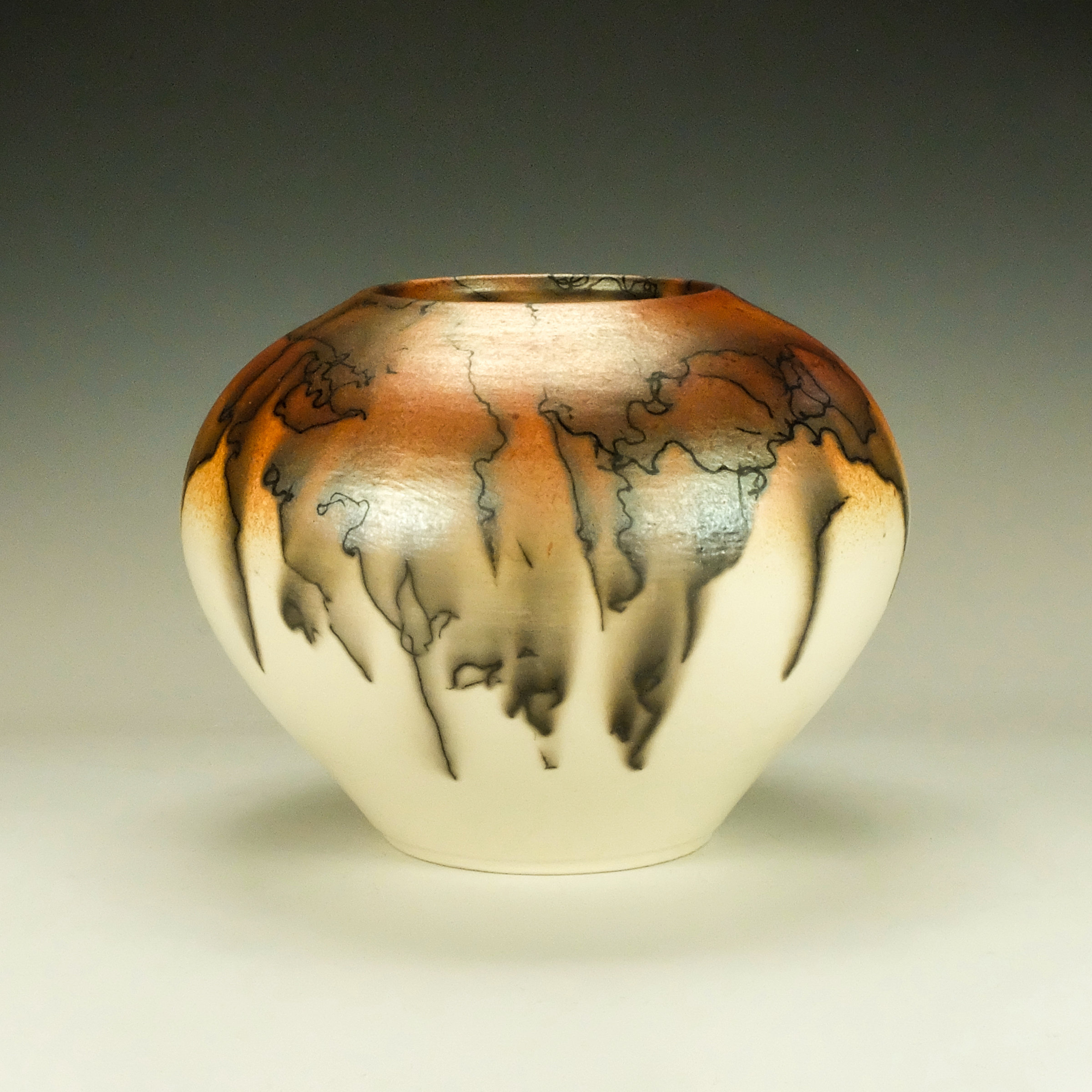 Hand polished orange Terra Sigillata. Raku horsehair pottery 